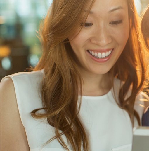 women watching something funny on a smartphone